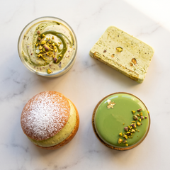 Gelato, semifreddo, bomba farcita e mousse cake al pistacchio su piano di marmo
