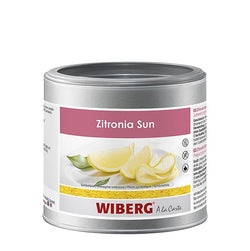 Barattolo Wiberg Zitronia limone naturale da 300 g accanto a limoni freschi e un filetto di pesce